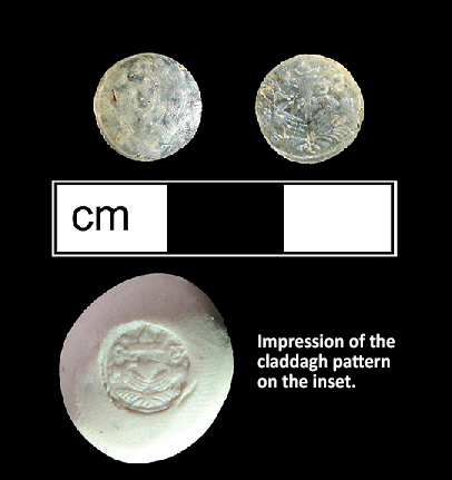 Colorless glass sleeve link inset with a claddagh pattern molded into the back